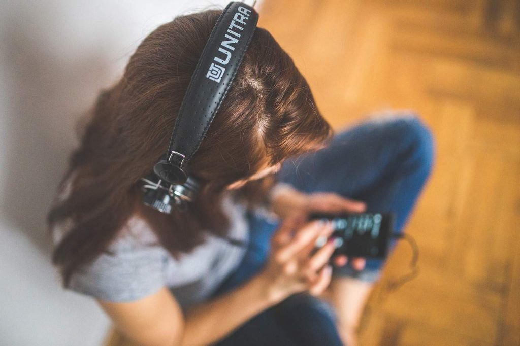 Woman Listening And Searching For Songs