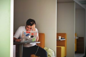 Man Looking At Laptop Frustrated